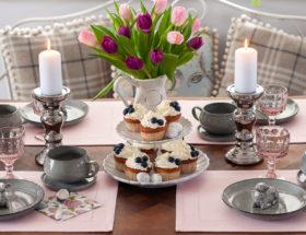 Wielkanocny stół nakryty w kolorach różu i srebra.