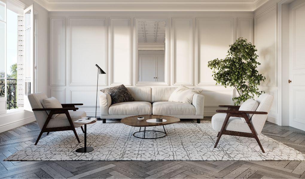 Nowoczesny salon z białymi listwami podłogowymi na białych ścianach i prostymi meblami.